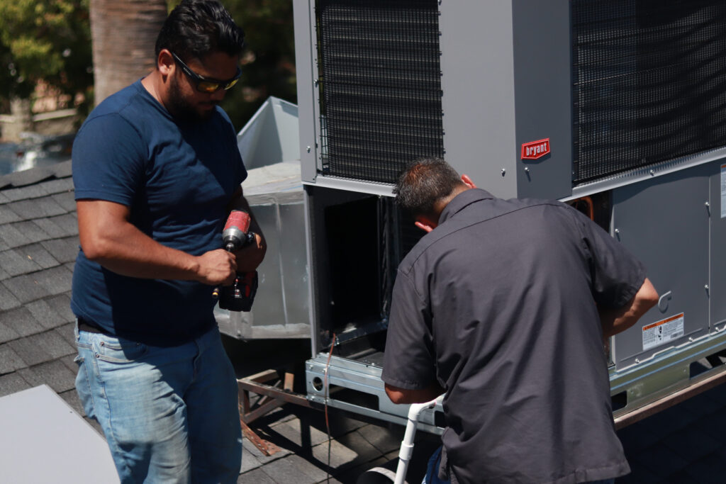 technicians working on air conditioner