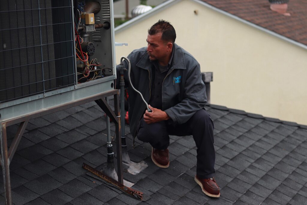 technician repairing air conditioner