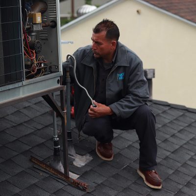technician repairing air conditioner